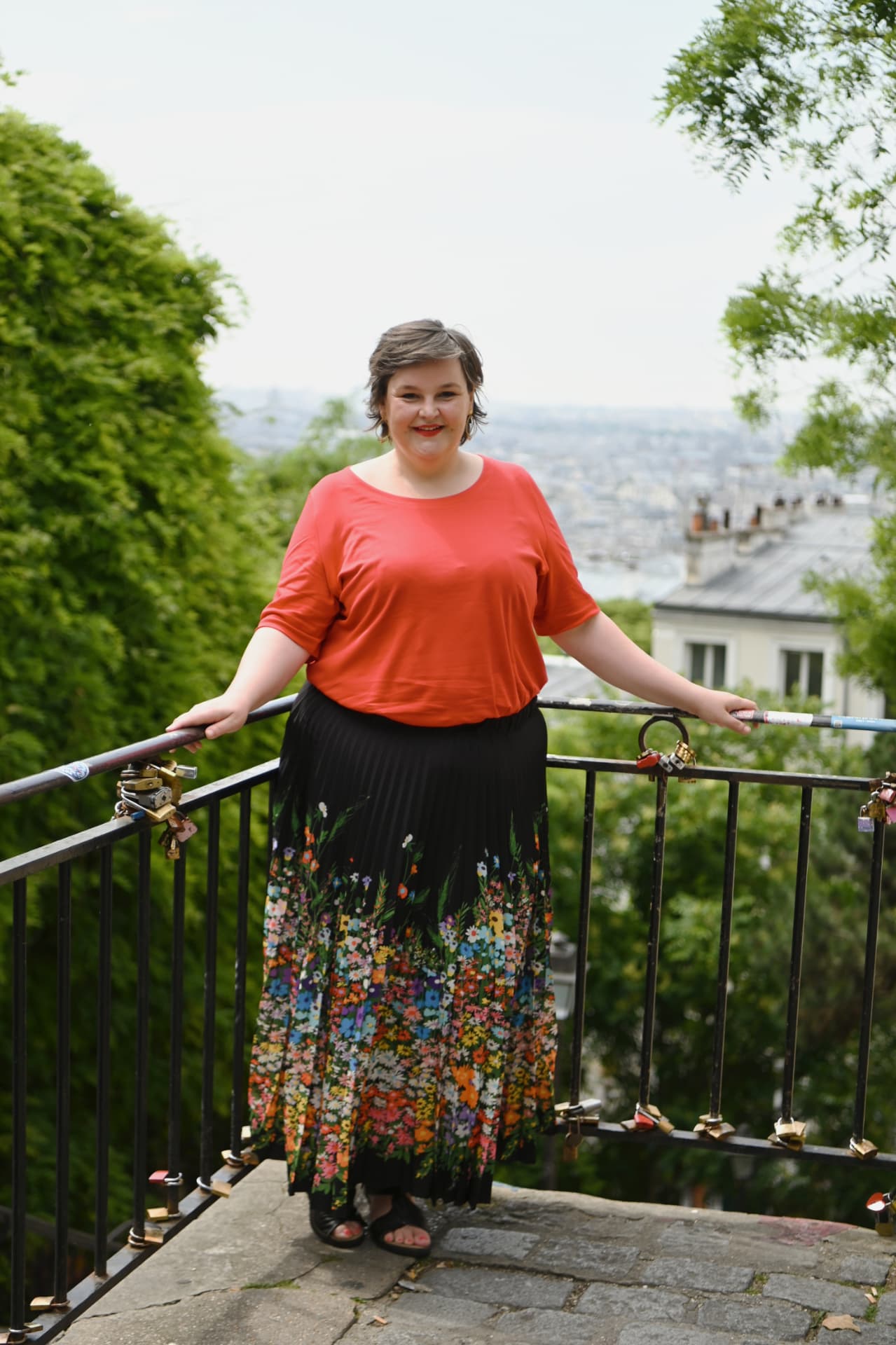 Sanne Frandsen smiling with a view over the rooftops of Paris