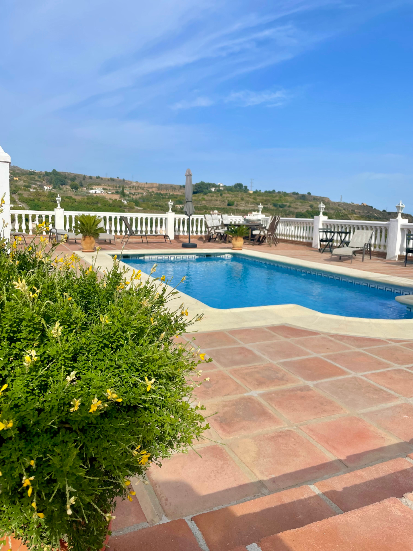 The pool and terrace at Villa Sunshine with views across the Andalusian hills